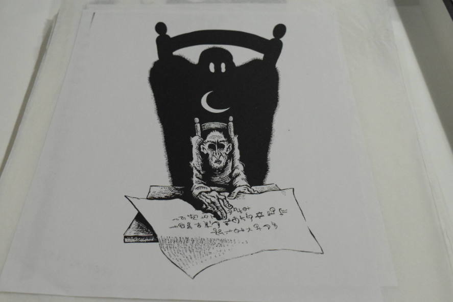 Ghoul in chair with paper containing symbols with ghost