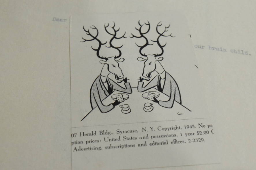 2 reindeer having tea and crackers cut out of magazine