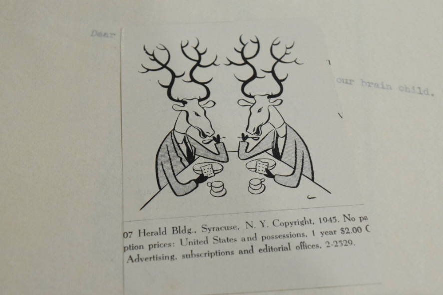 2 reindeer having tea and crackers cut out of magazine