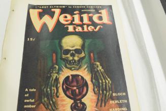 for November "Weird Tales" skull and skeletal hands near chalice