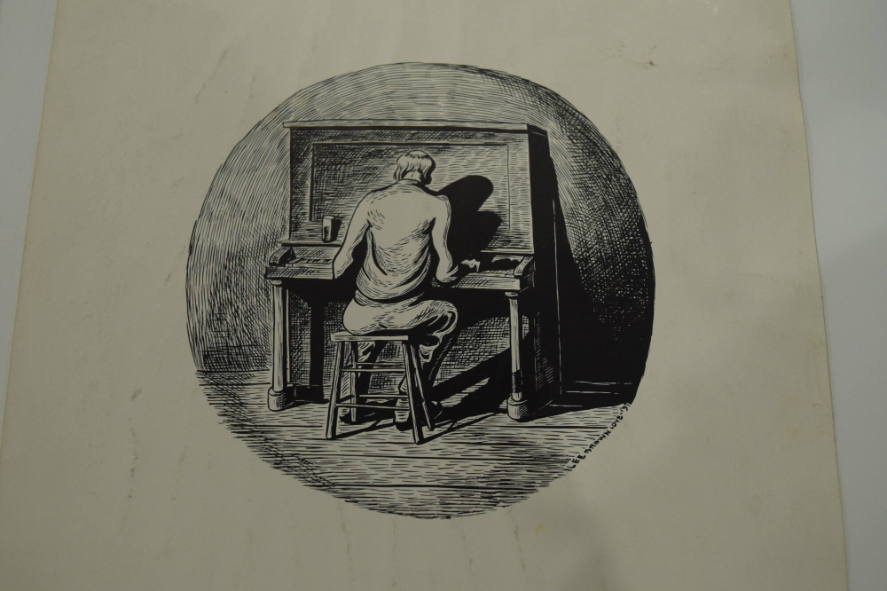 Man playing the piano with his back to the viewer